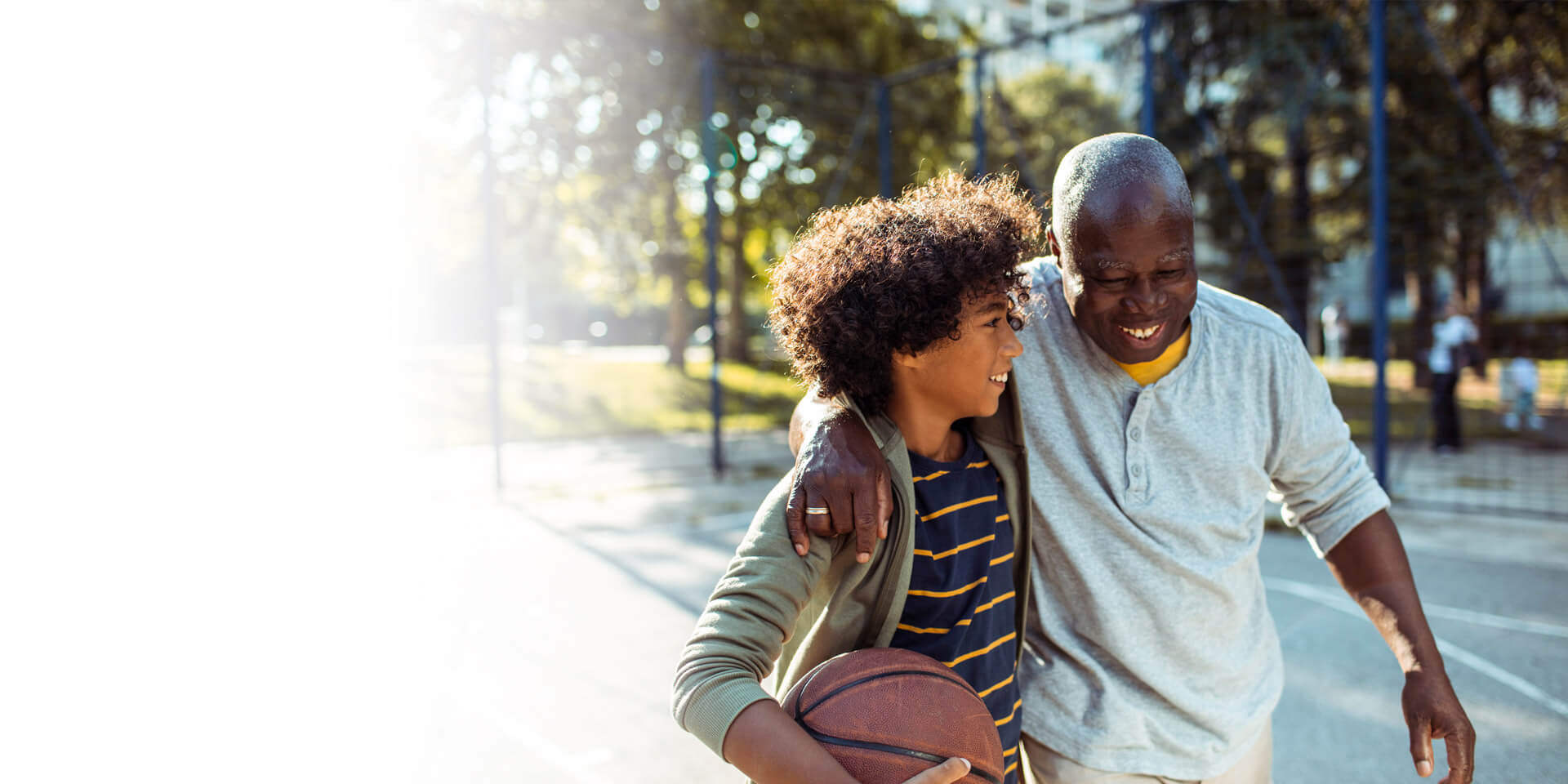 A dad playing basketball with his son